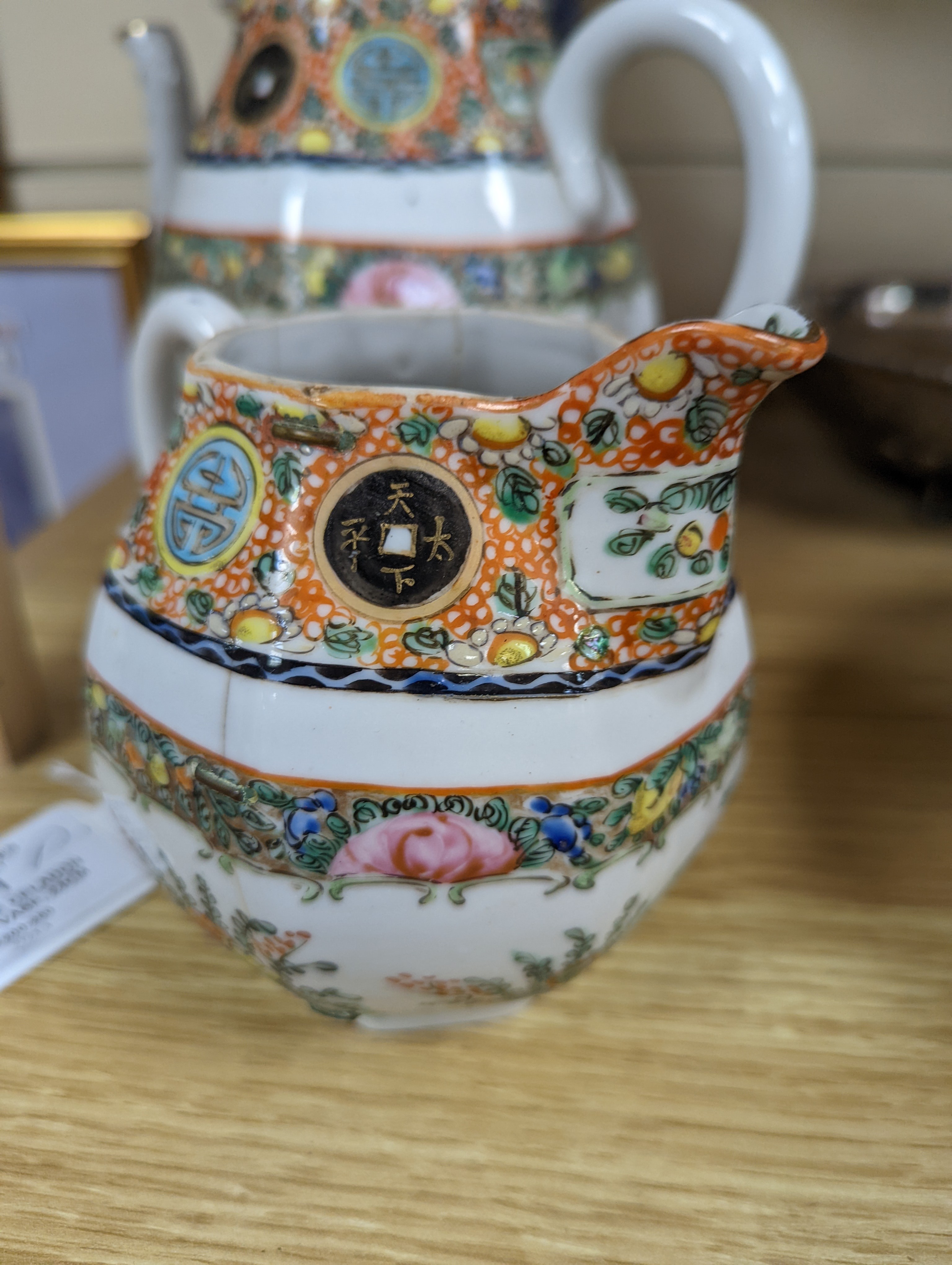 A Chinese celadon glazed vase, 24cm and a Chinese famille rose teapot and matching cream jug, a.f.